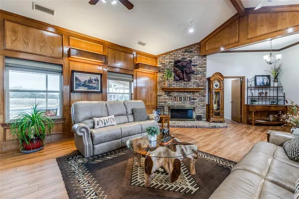 a living room with furniture fireplace and a window