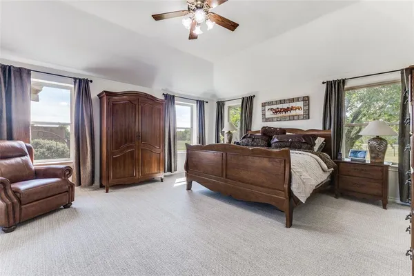 a bedroom with a bed and a couch