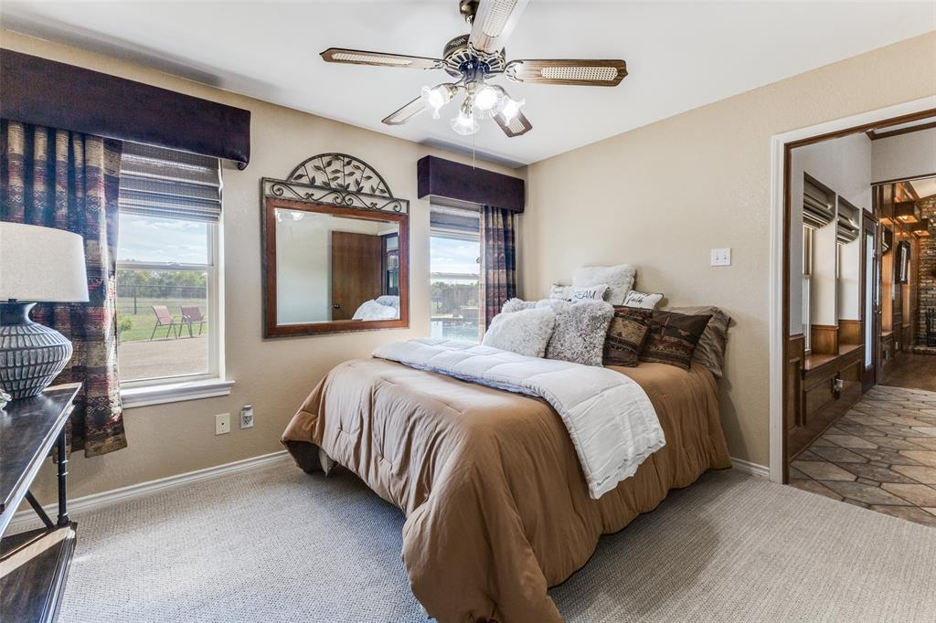 2525 Private Road 6040 Blue Ridge, TX 75424 - Photo 18 of 40 a bedroom with a bed next to a window with a chandelier