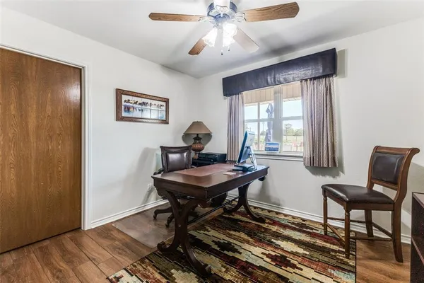 a view of a workspace with furniture and a window
