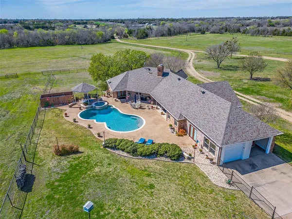 an aerial view of a house with outdoor space