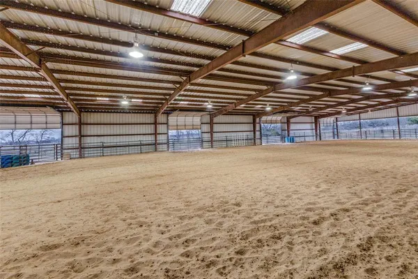 a view of an empty room with wooden ceiling