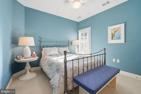 a bedroom with furniture and a lamp