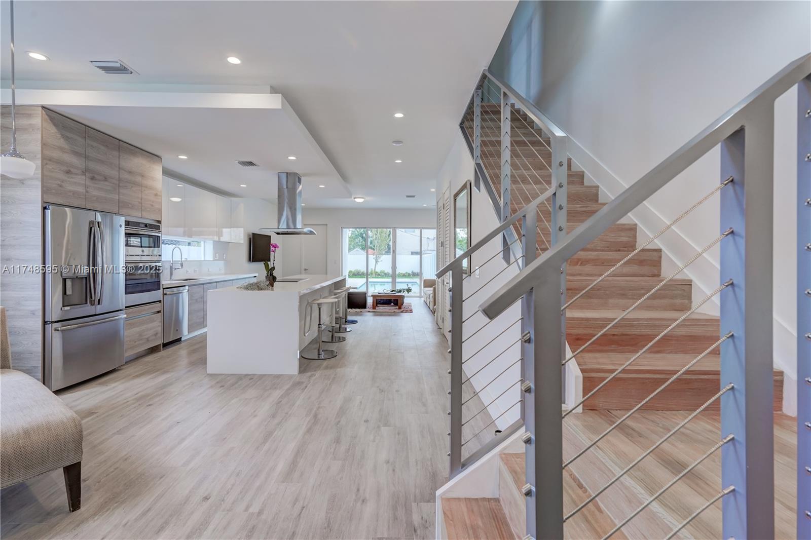 3570 Southwest 23rd Street, Unit 3570 Miami, FL 33145 - Photo 13 of 40 a view of kitchen and microwave with wooden floor