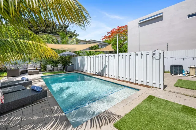 a backyard of a house with table and chairs