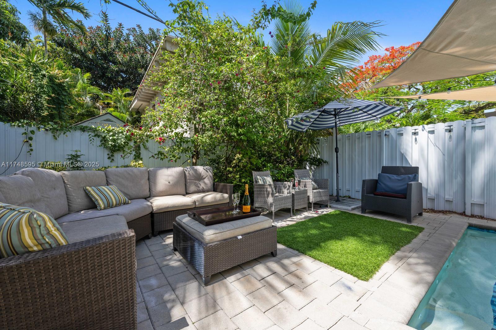 3570 Southwest 23rd Street, Unit 3570 Miami, FL 33145 - Photo 19 of 40 a backyard of a house with table and chairs