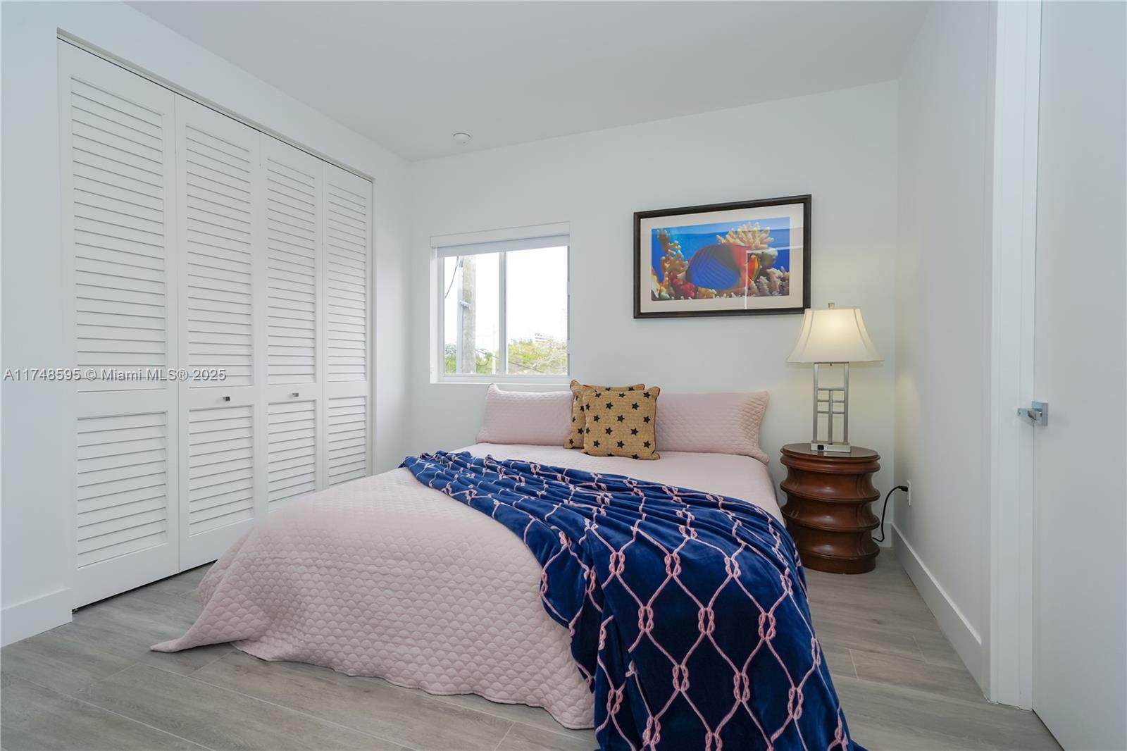 3570 Southwest 23rd Street, Unit 3570 Miami, FL 33145 - Photo 20 of 40 a bedroom with a bed and a lamp