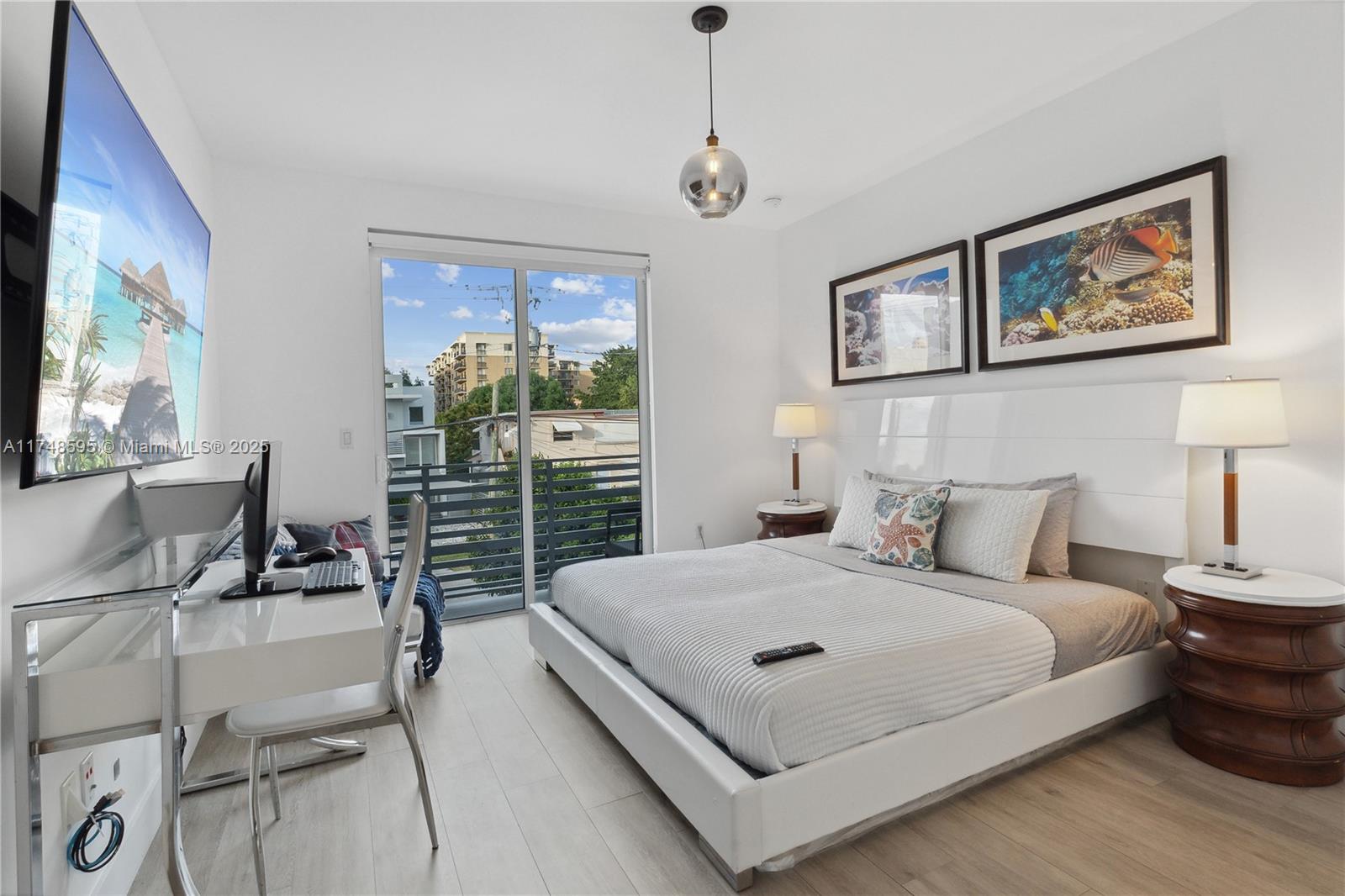 3570 Southwest 23rd Street, Unit 3570 Miami, FL 33145 - Photo 26 of 40 a bedroom with a bed and a flat screen tv