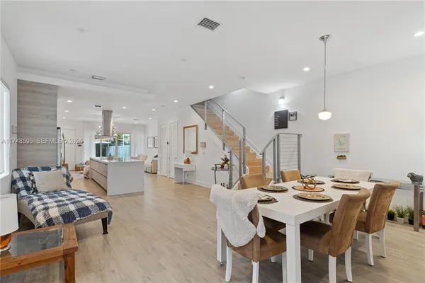 a living room with lots of furniture and a dining table