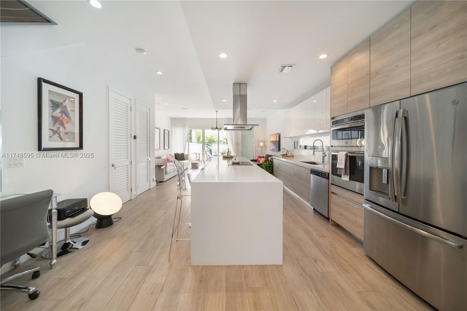 3570 Southwest 23rd Street, Unit 3570 Miami, FL 33145 - Photo 33 of 40 a living room with stainless steel appliances furniture wooden floor and a view of kitchen