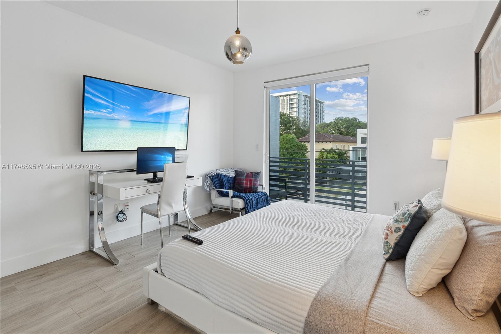 3570 Southwest 23rd Street, Unit 3570 Miami, FL 33145 - Photo 36 of 40 a bedroom with a bed and a chair