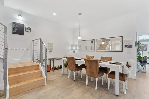 a living room with furniture kitchen view and a flat screen tv