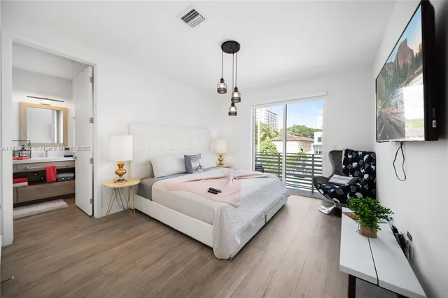 a living room with furniture a window and a flat screen tv