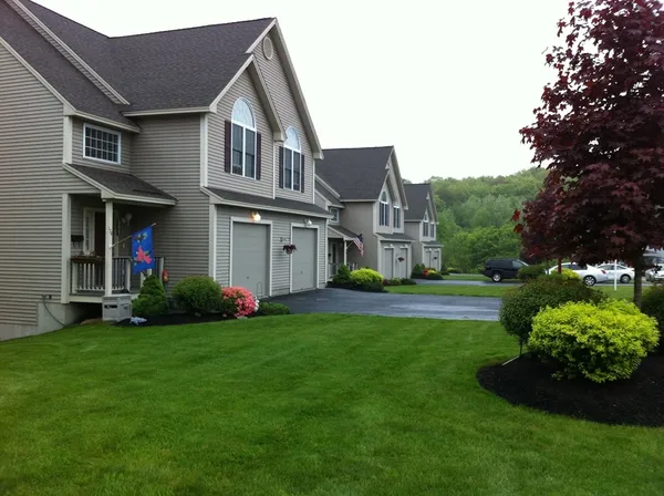 a front view of house with yard and green space