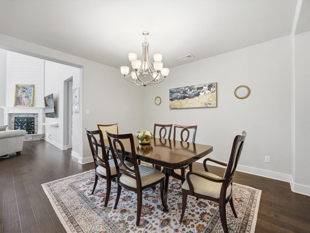 146 Old Bridge Road Waxahachie, TX 75165 - Photo 12 of 40 a dining room with furniture wooden floor a rug and a chandelier