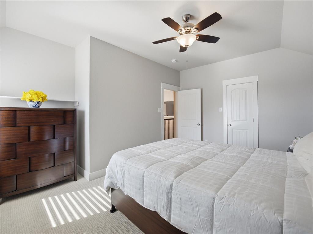146 Old Bridge Road Waxahachie, TX 75165 - Photo 24 of 40 a bedroom with a bed and a chandelier