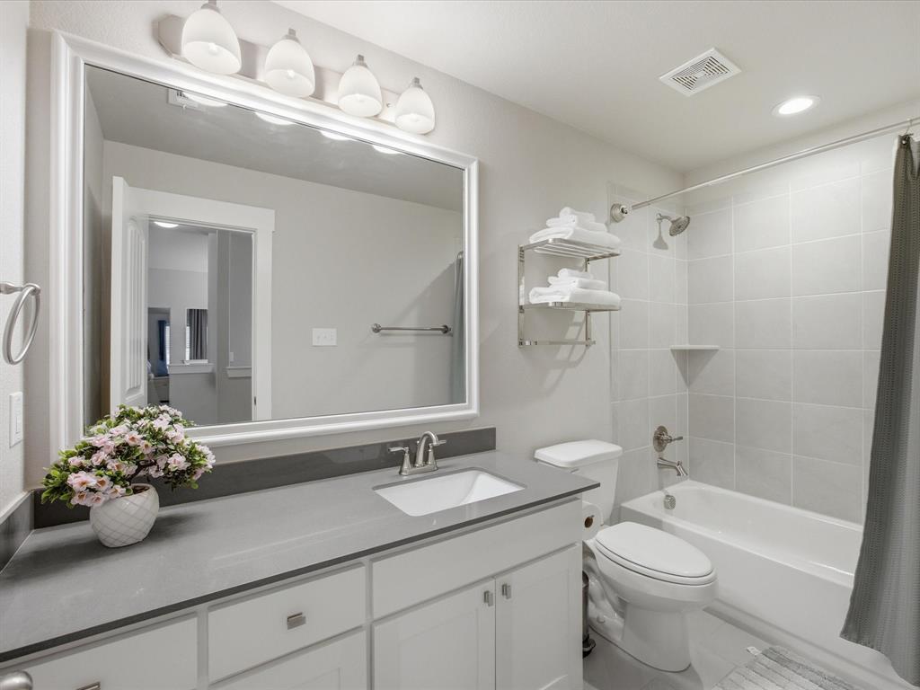 146 Old Bridge Road Waxahachie, TX 75165 - Photo 25 of 40 a bathroom with a granite countertop sink a toilet and shower