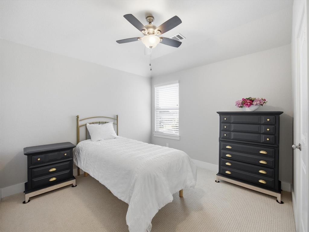 146 Old Bridge Road Waxahachie, TX 75165 - Photo 28 of 40 a bedroom with a bed and a chandelier