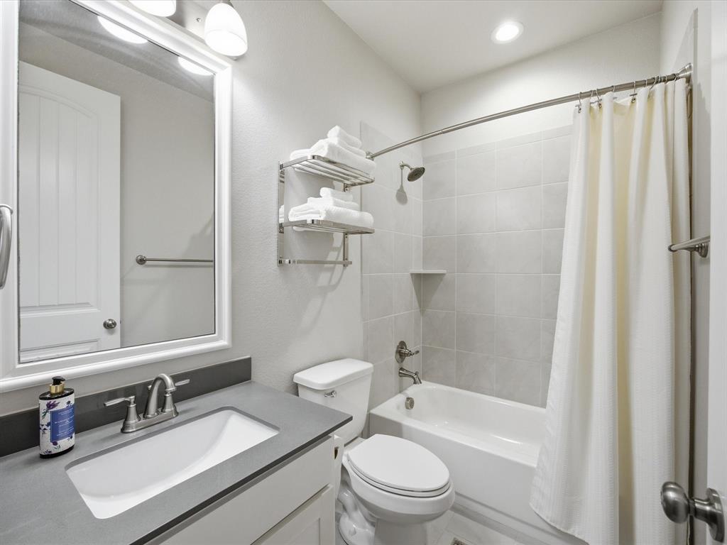 146 Old Bridge Road Waxahachie, TX 75165 - Photo 8 of 40 a bathroom with a sink a toilet a mirror and shower