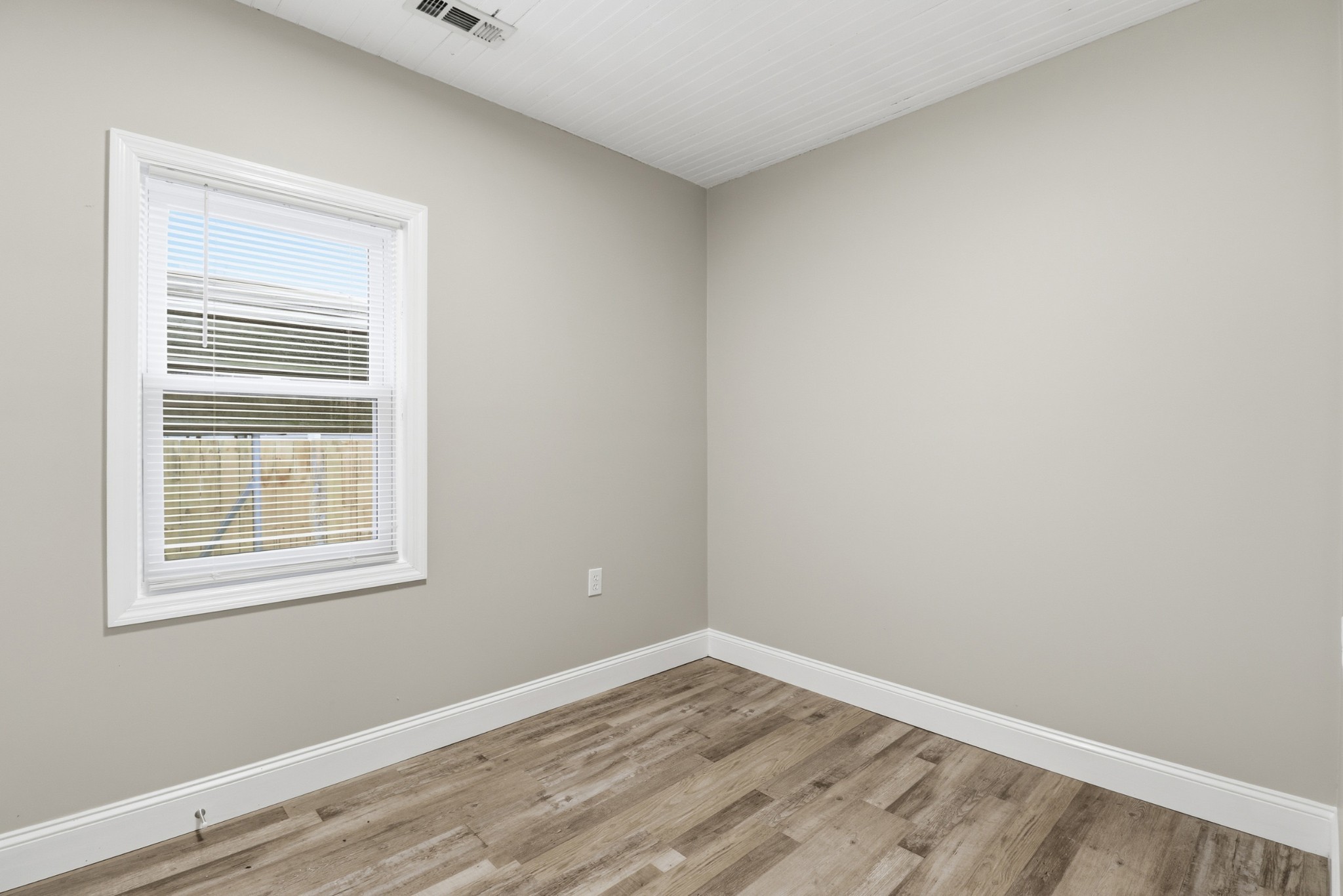 612 Maple Street Manchester, TN 37355 - Photo 12 of 20 a view of an empty room with wooden floor and a window