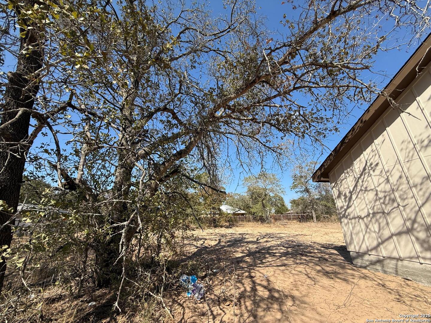 48 Grey Fox Poteet, TX 78065 - Photo 12 of 16 a view of a yard with wooden fence