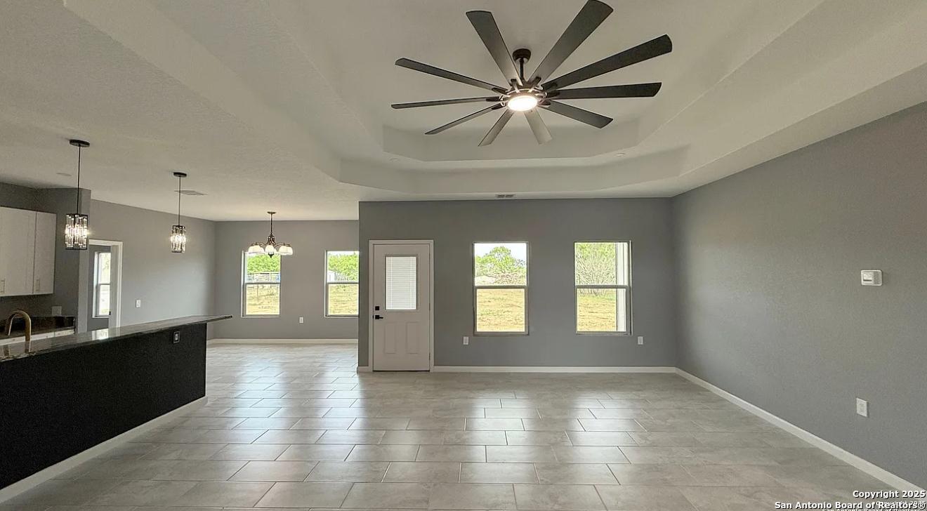 48 Grey Fox Poteet, TX 78065 - Photo 4 of 16 an empty room with wooden floor and windows