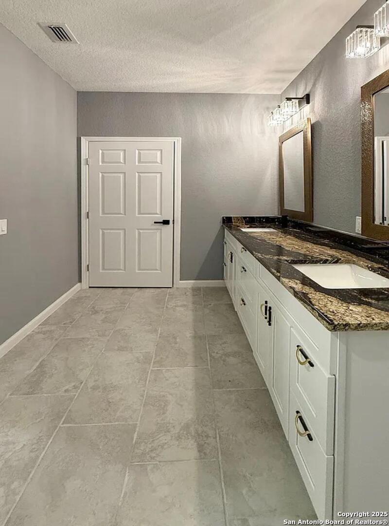 48 Grey Fox Poteet, TX 78065 - Photo 8 of 16 a bathroom with granite countertop double vanity and mirrors