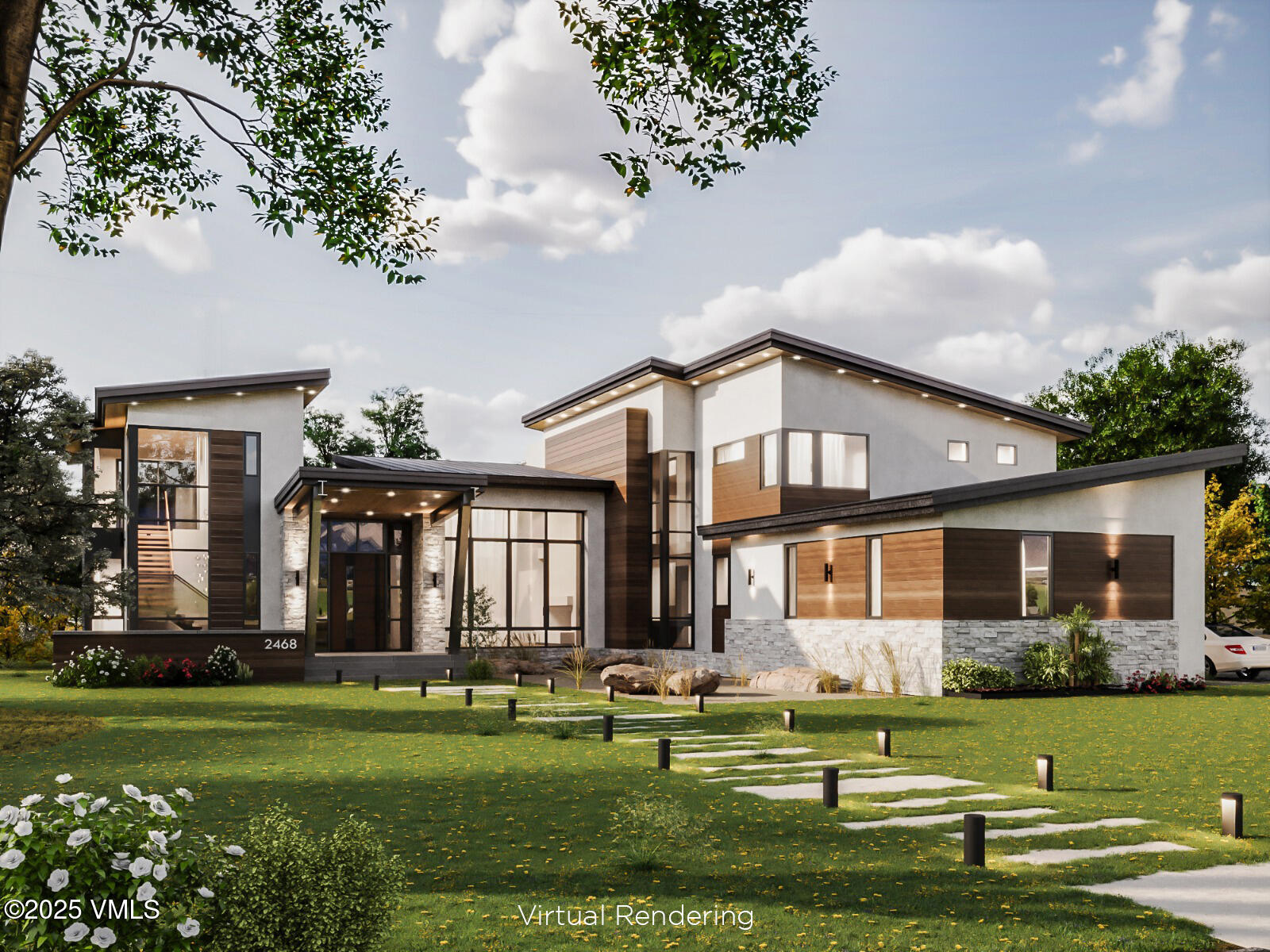 a front view of a house with a garden and trees