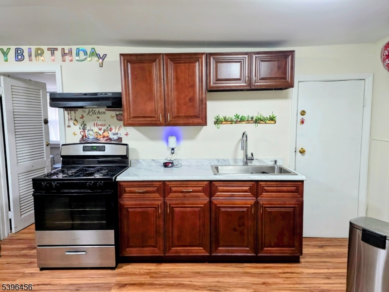 a kitchen with stainless steel appliances a stove and a microwave