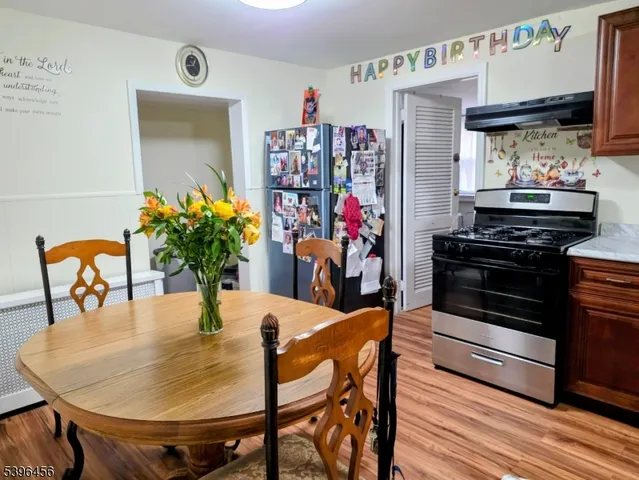 a dining room with furniture and wooden floor