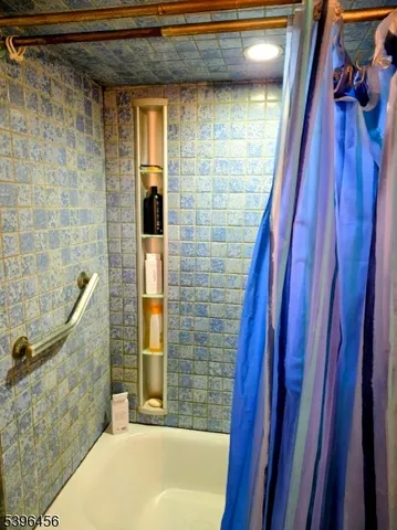 a bathroom with a bathtub and shower