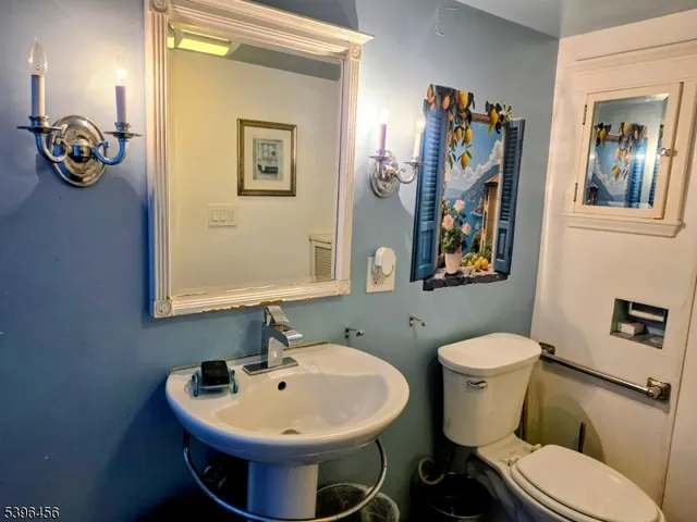a bathroom with a toilet sink and mirror