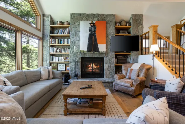 a living room with furniture fireplace and flat screen