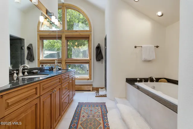 a large kitchen with a window a sink and stainless steel appliances