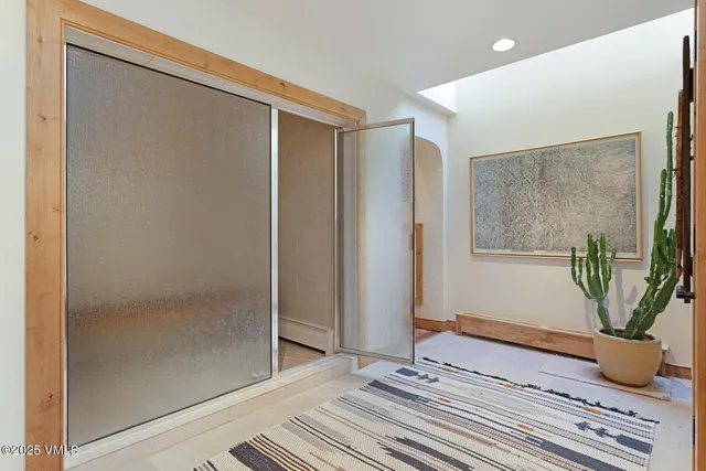 a view of a livingroom with wooden floor and a potted plant