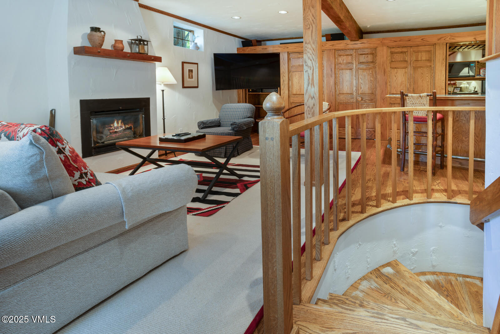 2111 Vermont Road, Unit A Vail, CO 81657 - Photo 16 of 46 a living room with furniture a fireplace and a flat screen tv