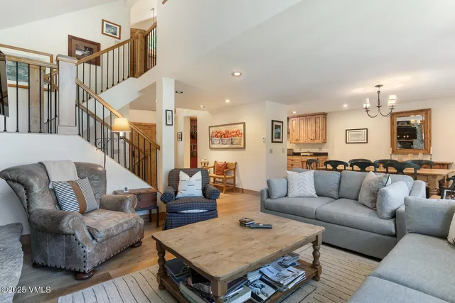 a living room with furniture kitchen view and a table