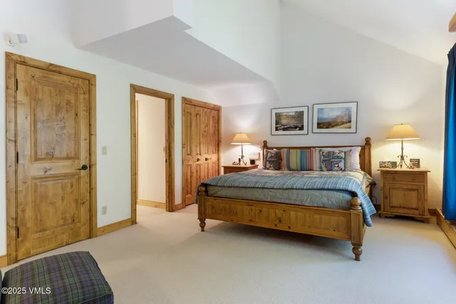 a bedroom with a bed and a night stand