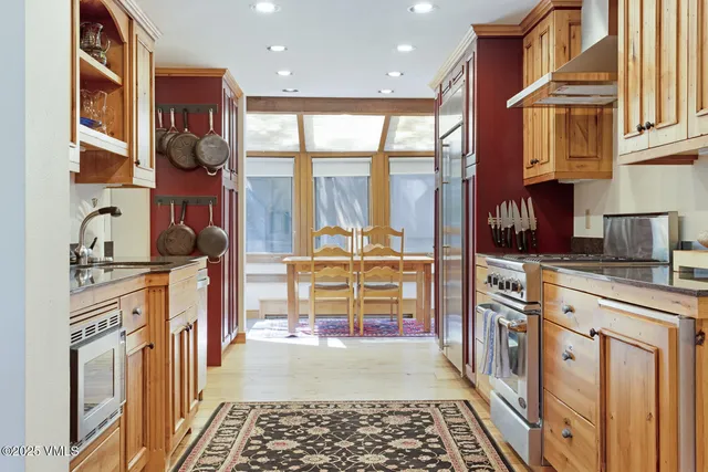a kitchen with stainless steel appliances granite countertop a stove a sink and a refrigerator