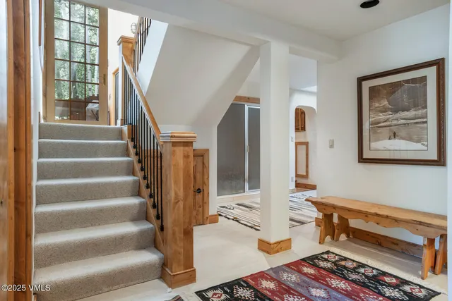 a view of hall way with furniture and stairs
