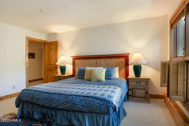 a bedroom with a bed and cabinets