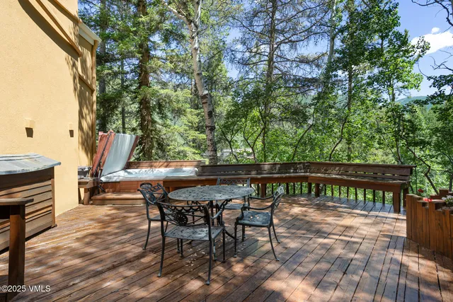 a view of backyard with furniture and wooden deck