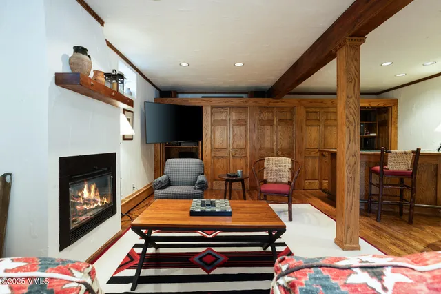 a living room with furniture a flat screen tv and a fireplace