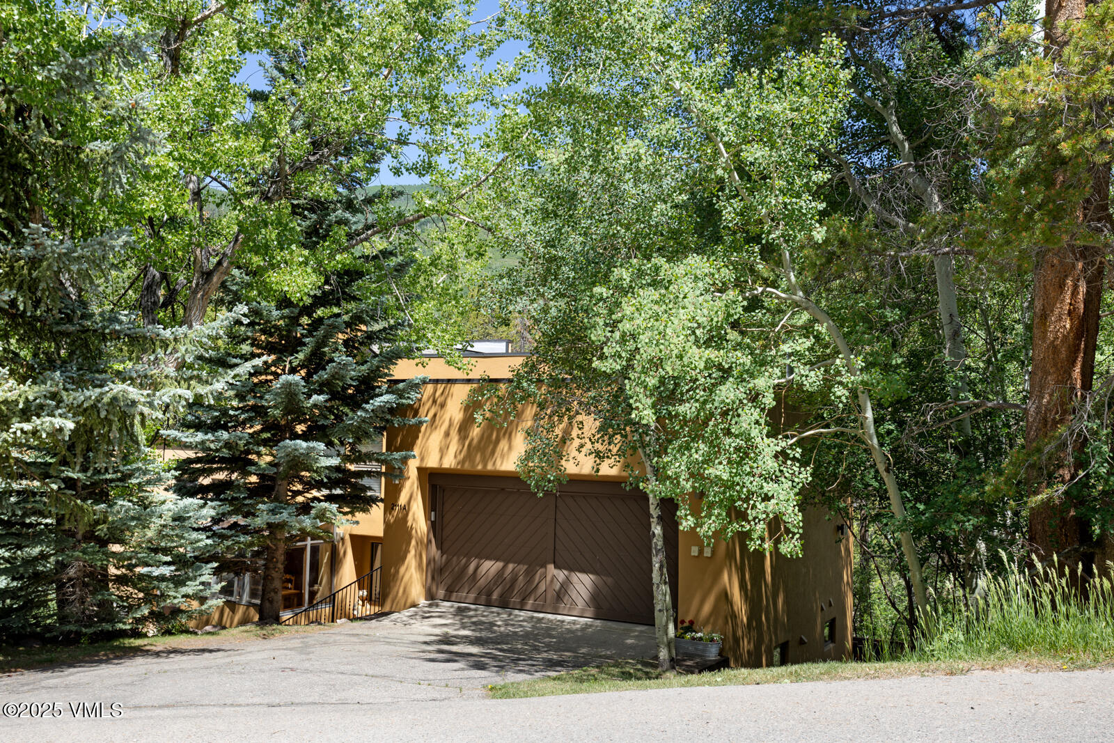2111 Vermont Road, Unit A Vail, CO 81657 - Photo 43 of 46 a front view of a house with a yard