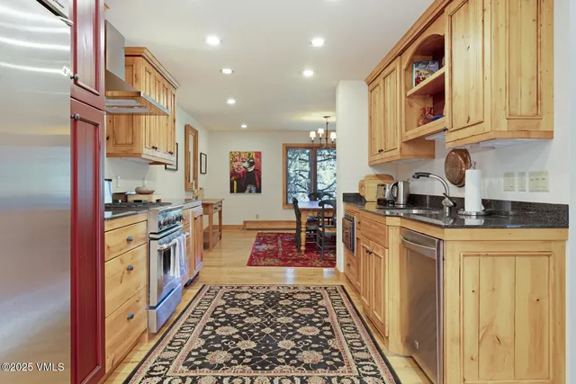 a kitchen with stainless steel appliances granite countertop a stove a sink dishwasher and a refrigerator