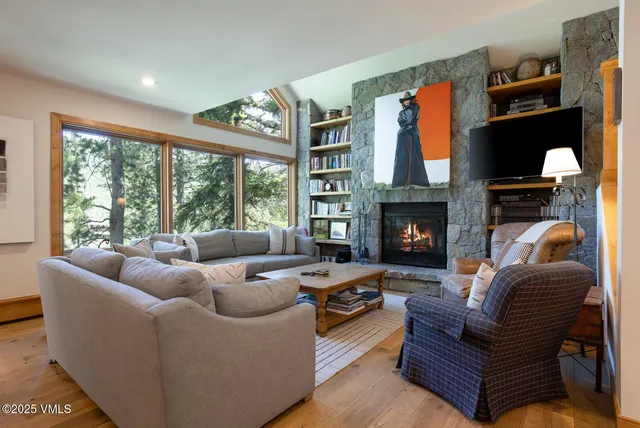 a living room with furniture fireplace and flat screen tv
