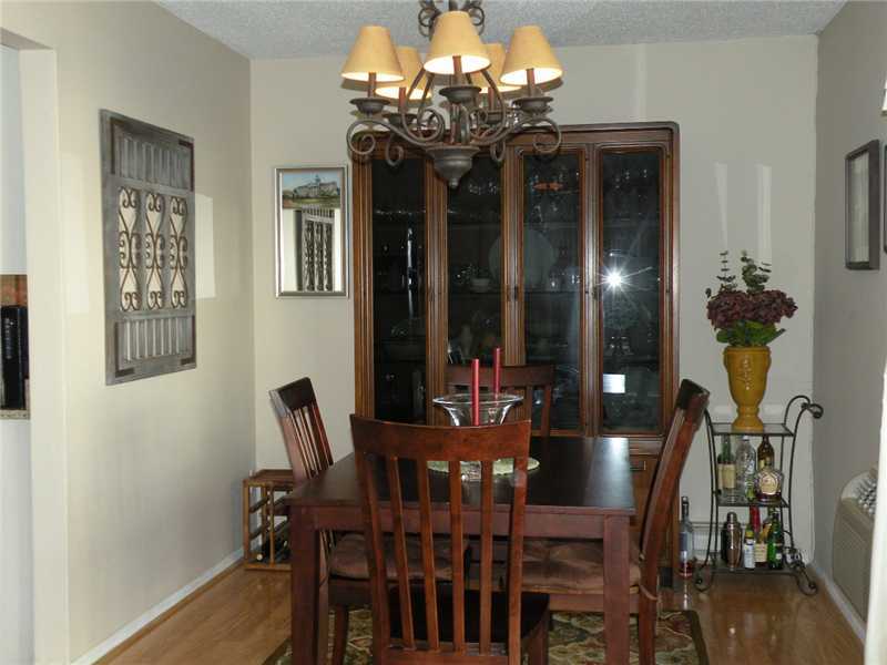 377 Glenbrook Road Stamford, CT 06906 - Photo 7 of 15 a view of a dining room with furniture a chandelier and wooden floor