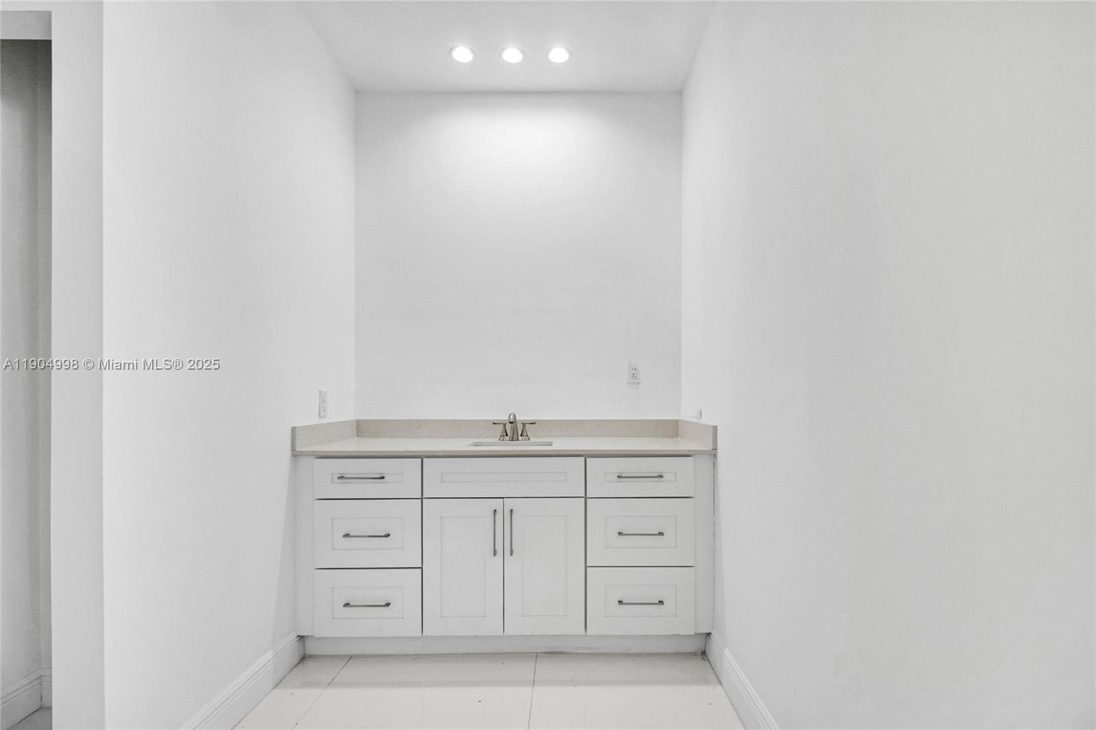 425 Southwest 129th Avenue Miami, FL 33184 - Photo 12 of 24 a bathroom with a granite countertop sink and vanity