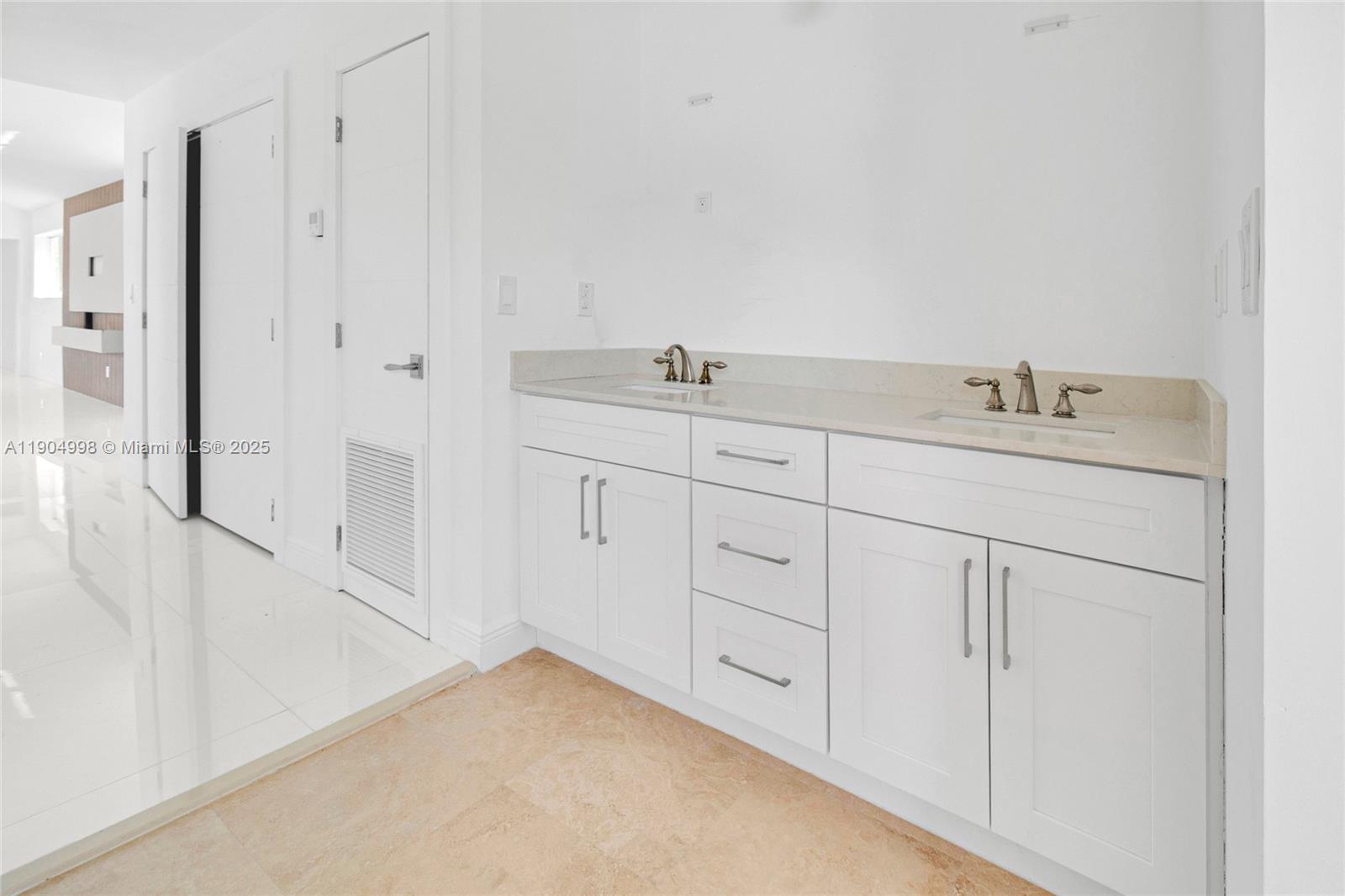 425 Southwest 129th Avenue Miami, FL 33184 - Photo 17 of 24 a bathroom with a granite countertop sink and white cabinets