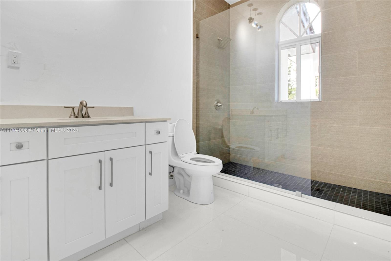 425 Southwest 129th Avenue Miami, FL 33184 - Photo 22 of 24 a bathroom with a sink a toilet and a mirror